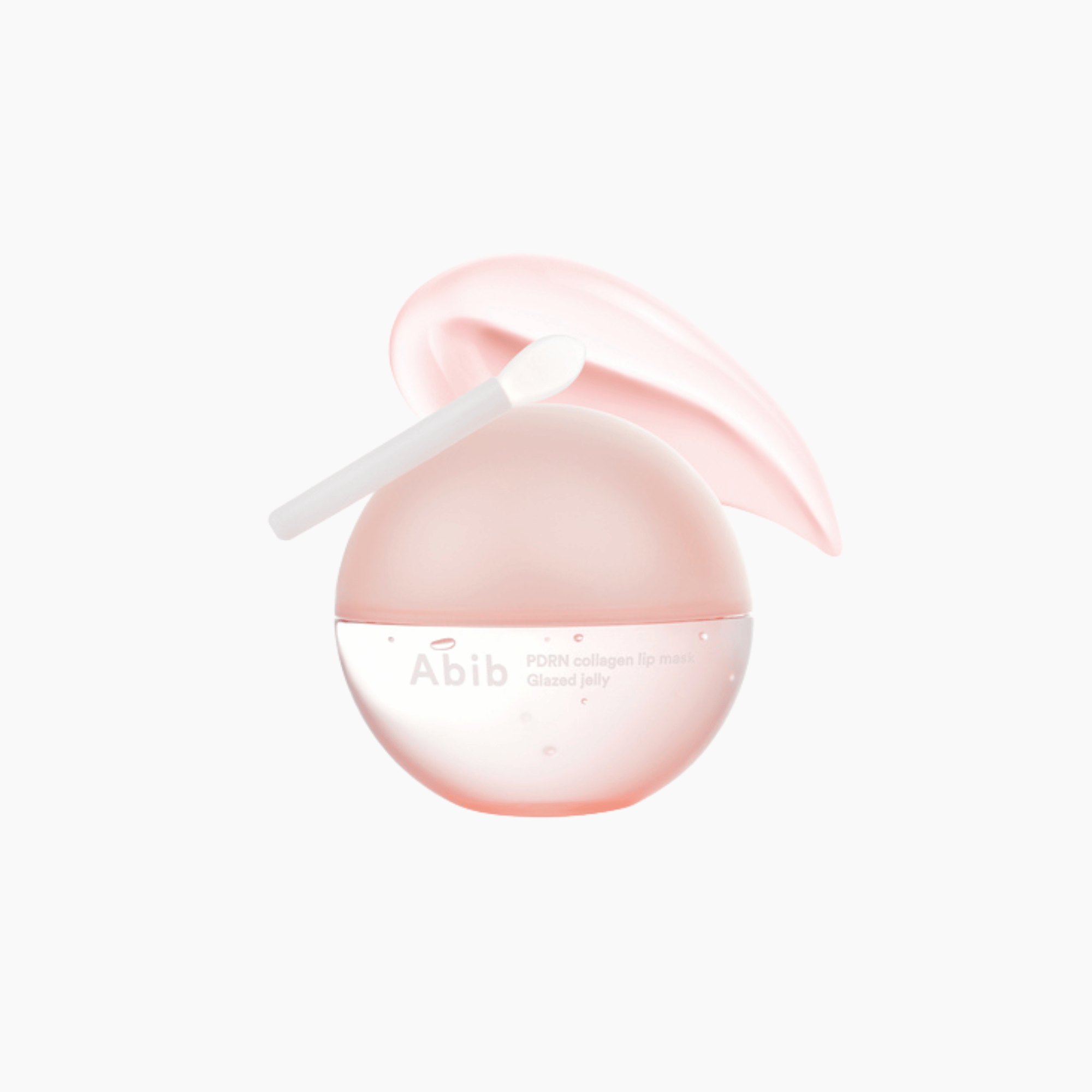 Eine rosafarbene, kugelförmige Abib PDRN Collagen Lip Mask mit einem kleinen Applikator auf der Oberseite ist vor einem weißen Hintergrund abgebildet.