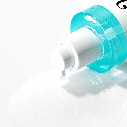 Nahaufnahme der Pumpflasche vom Anua BHA 2% Toner, ein Tropfen der transparenten Textur liegt auf weißer Oberfläche